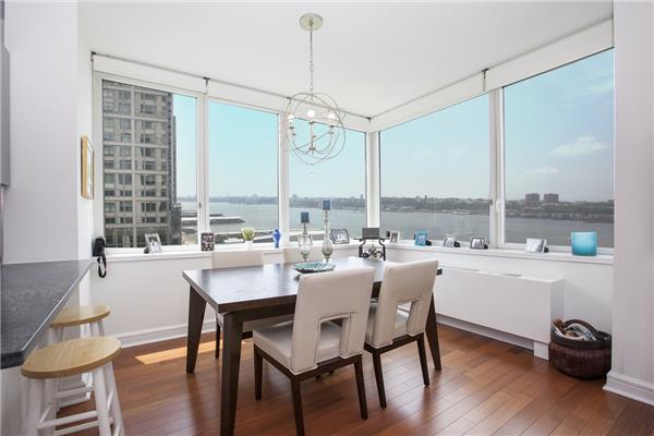 100 Riverside Boulevard, Unit 23D Manhattan, NY 10069 - Photo 2 of 13 a large kitchen with a table and chairs