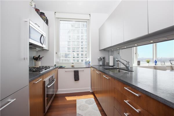 100 Riverside Boulevard, Unit 23D Manhattan, NY 10069 - Photo 3 of 13 a kitchen with stainless steel appliances granite countertop a sink a stove and a refrigerator