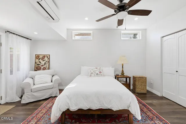 a bedroom with a bed and a couch