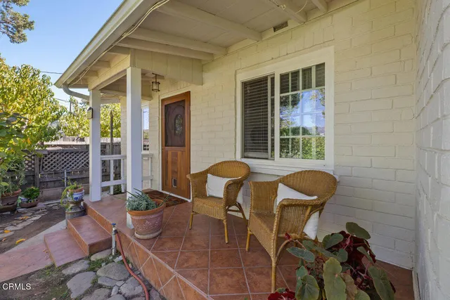 a view of a patio with table and chairs and potted plants