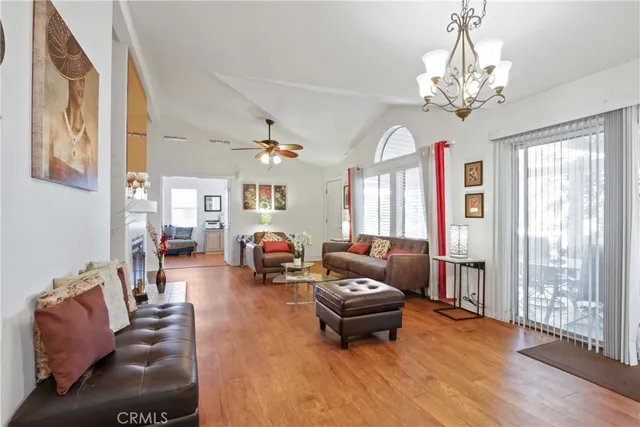 a living room with furniture a window and a flat screen tv