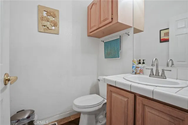 a bedroom with a bed and a mirror on dresser