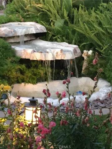 a view of a patio with table and chairs under an umbrella