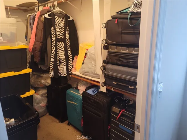 a bedroom with a bed couch and window