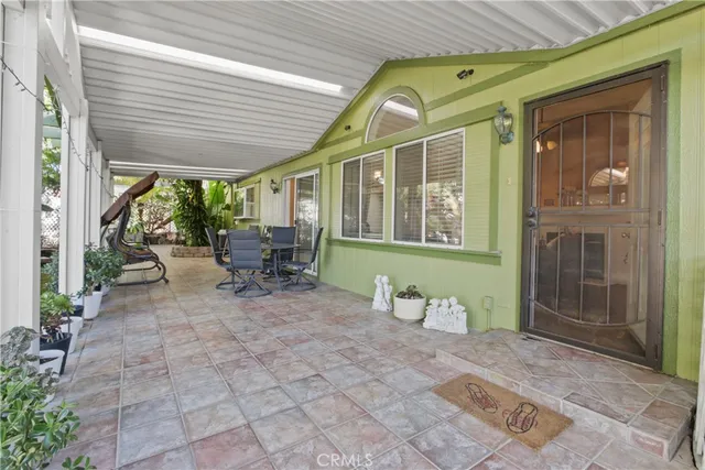 a building outdoor space with patio furniture and potted plants