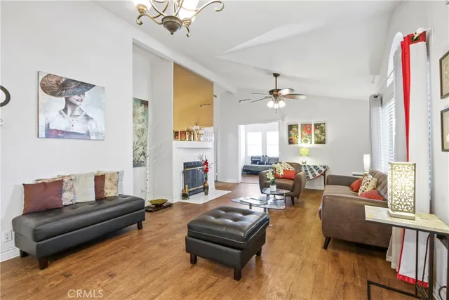 a living room with furniture a fireplace and a chandelier