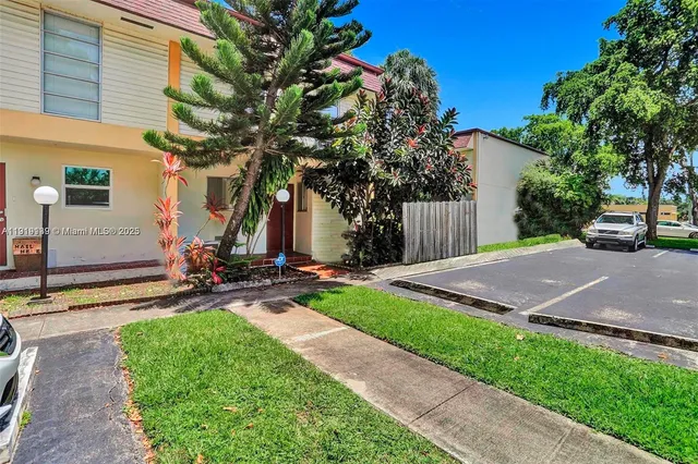 a view of a street with a large tree