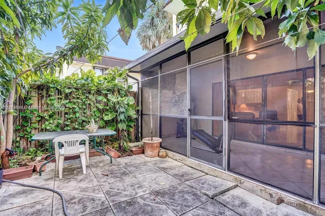 a backyard of a house with table and chairs