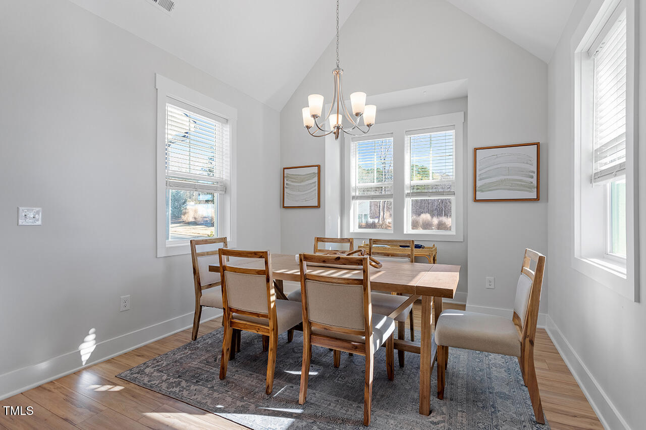 539 Vine Parkway Pittsboro, NC 27312 - Photo 11 of 35 a view of a dining room with furniture window and wooden floor