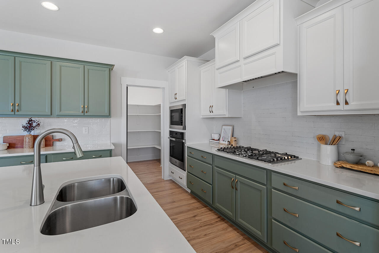 539 Vine Parkway Pittsboro, NC 27312 - Photo 15 of 35 a kitchen with sink a stove and cabinets