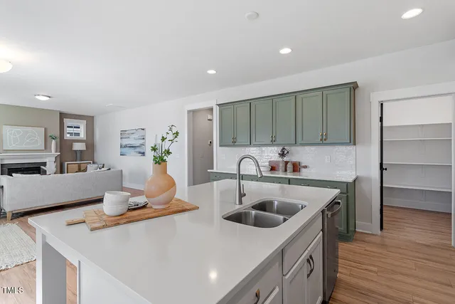 a kitchen with a sink a stove and cabinets