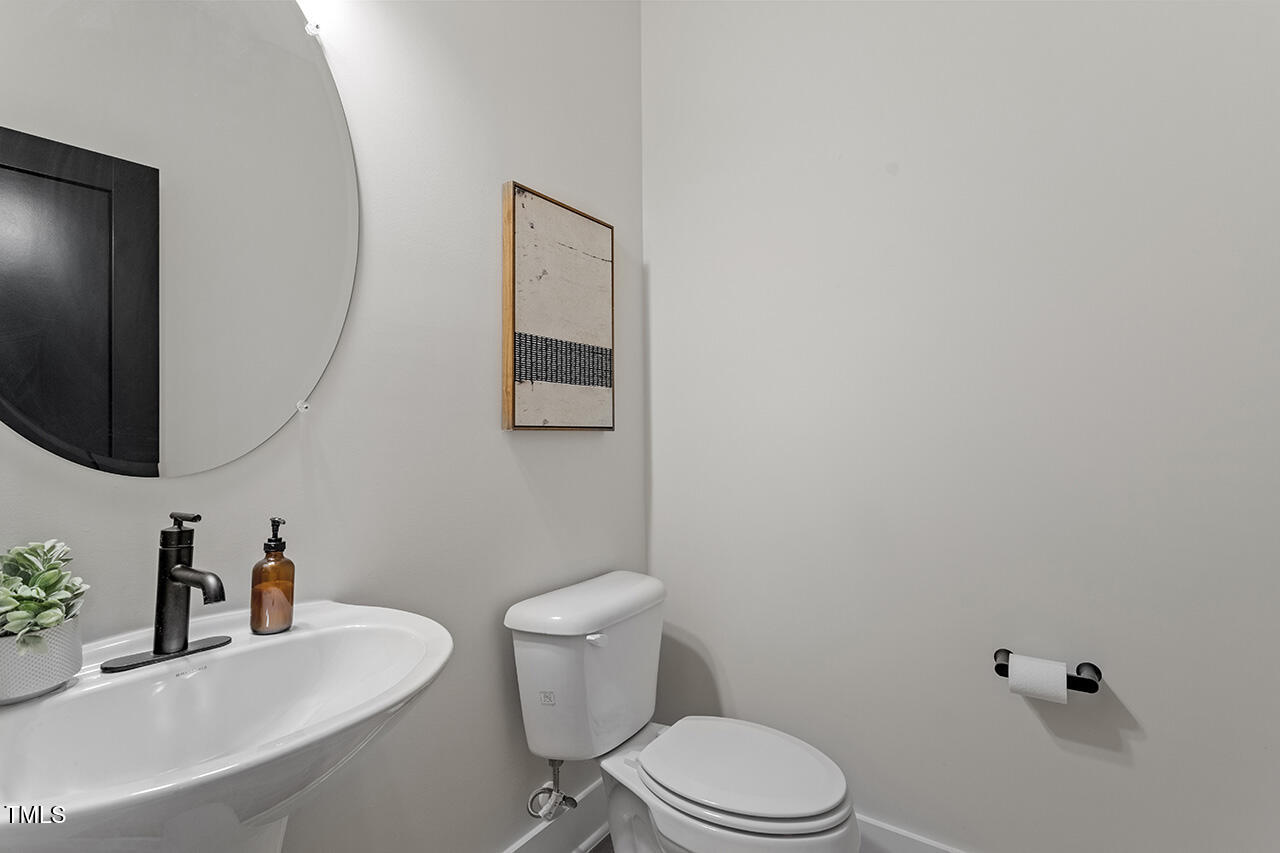 539 Vine Parkway Pittsboro, NC 27312 - Photo 19 of 35 a white toilet sitting next to a bathroom sink