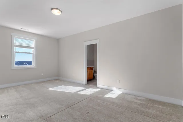 a bathroom with a sink a toilet and a window