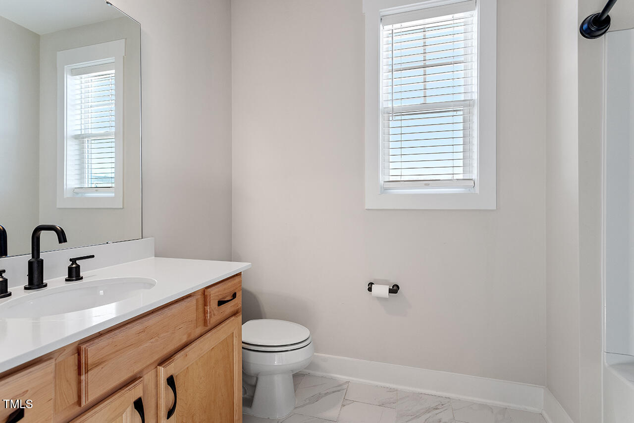 539 Vine Parkway Pittsboro, NC 27312 - Photo 27 of 35 a bathroom with a sink a toilet and a window