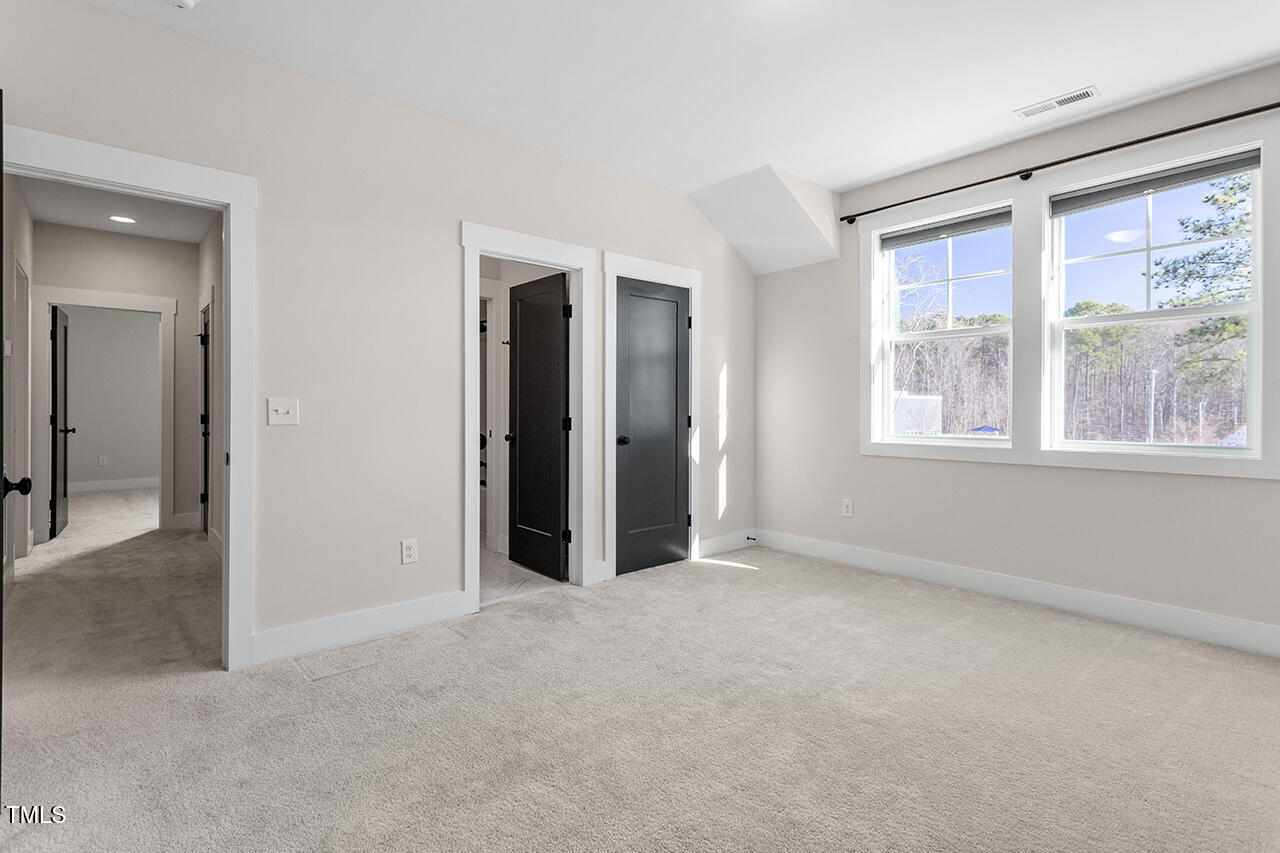 539 Vine Parkway Pittsboro, NC 27312 - Photo 31 of 35 an empty room with windows and closet
