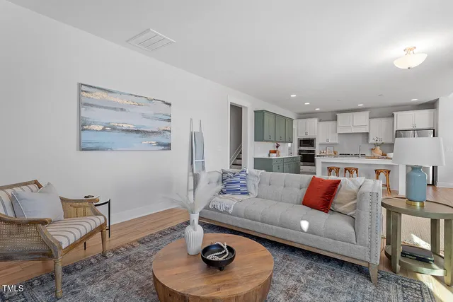 a living room with furniture and a kitchen