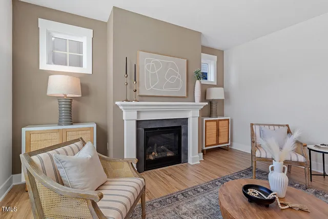 a living room with furniture a window and a fireplace