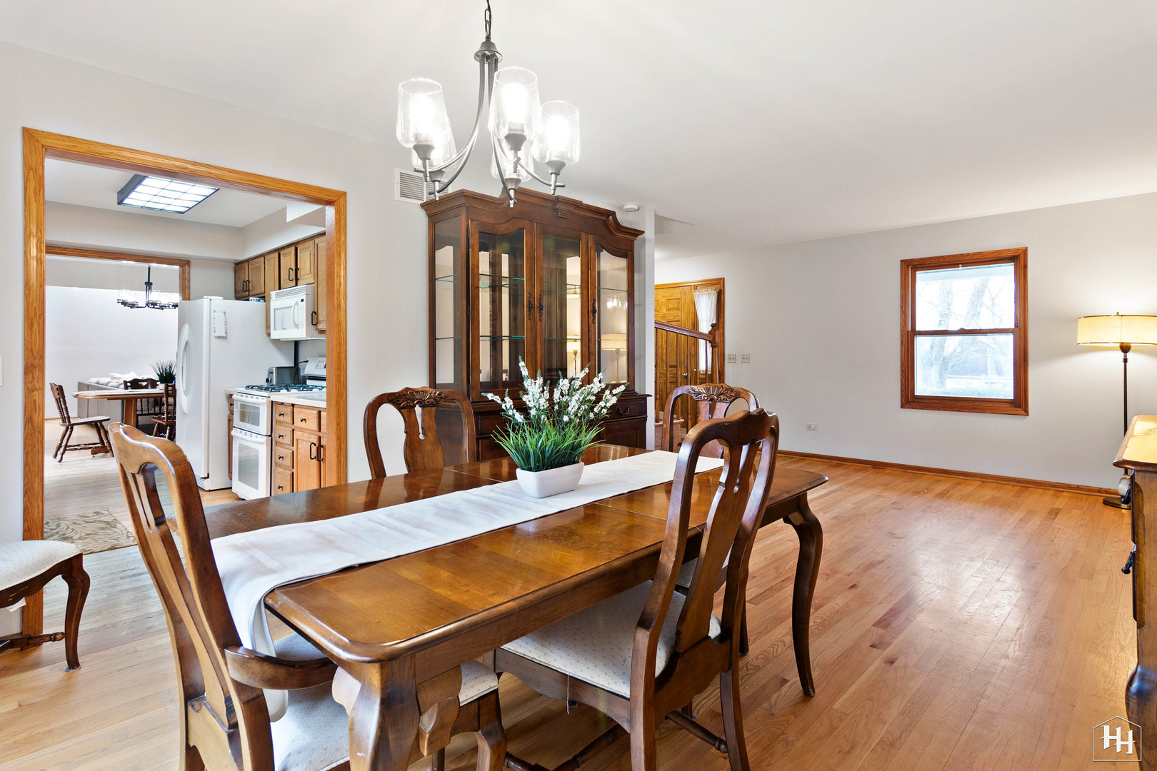 355 Hillhurst Drive Cary, IL 60013 - Photo 8 of 29 a dining room with furniture a chandelier and wooden floor