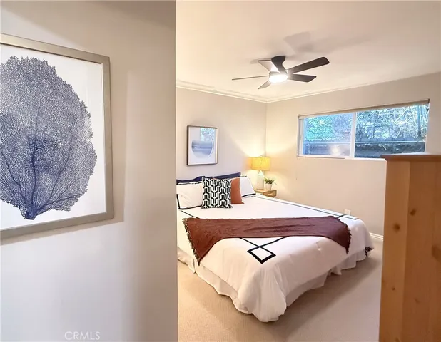 a bedroom with a bed and wall painting