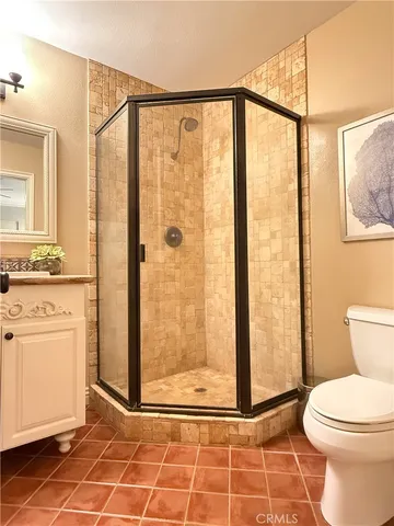 a bathroom with a shower and a toilet