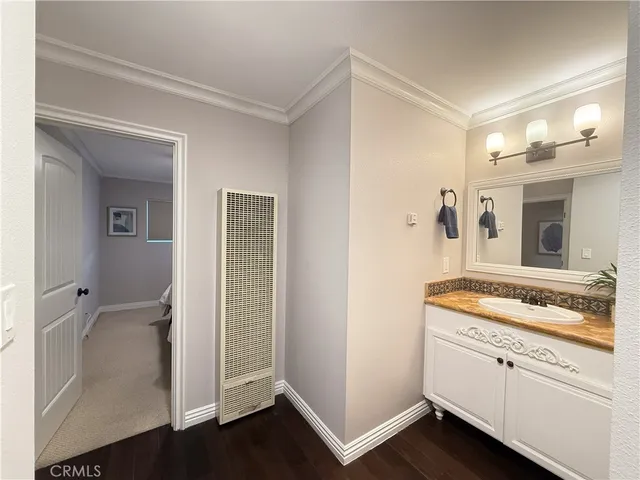 a hallway with sink and wooden floor
