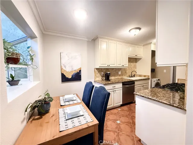 a kitchen with a stove a sink and a refrigerator