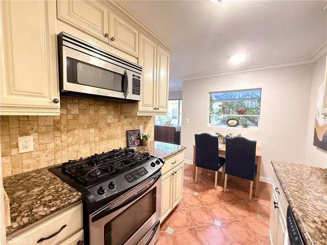 a kitchen with stainless steel appliances granite countertop a stove top oven a sink dishwasher and granite countertops