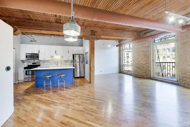 a view of a kitchen with a stove cabinets and wooden floor