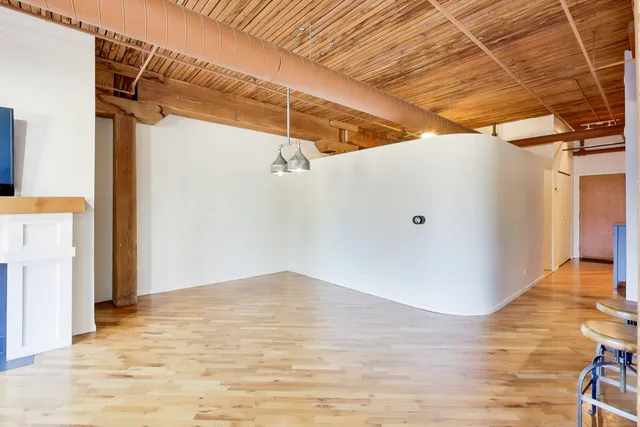 a view of a room with wooden floor