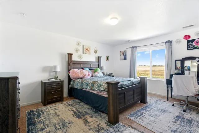 a bedroom with a bed and a television