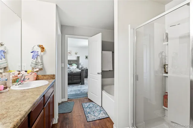 a bed room with furniture and mirror