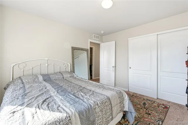 a bathroom with a granite countertop sink a toilet and a mirror
