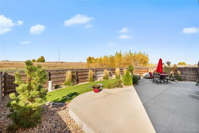 a view of a patio with table and chairs and potted plants