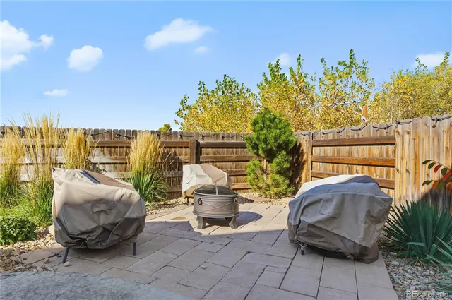 a view of a sitting area with furniture and wooden fence