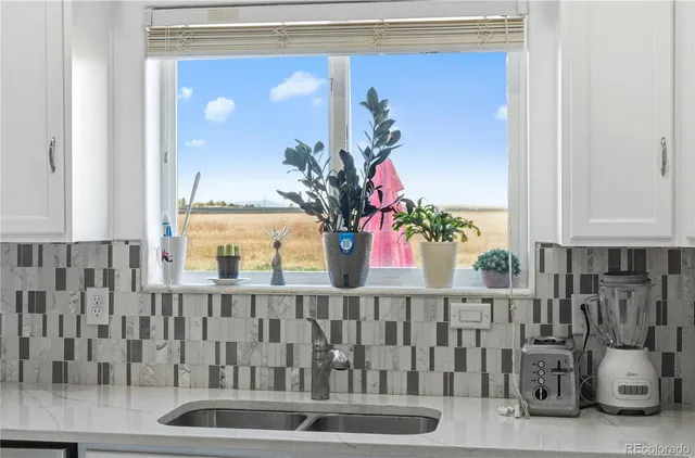 a kitchen with a dining table chairs and refrigerator