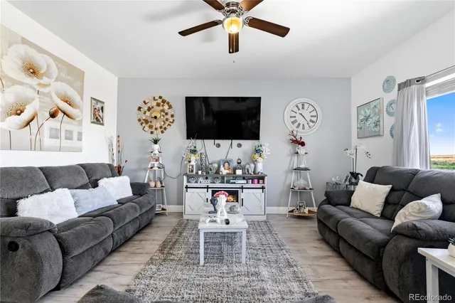 a living room with furniture kitchen view and a window
