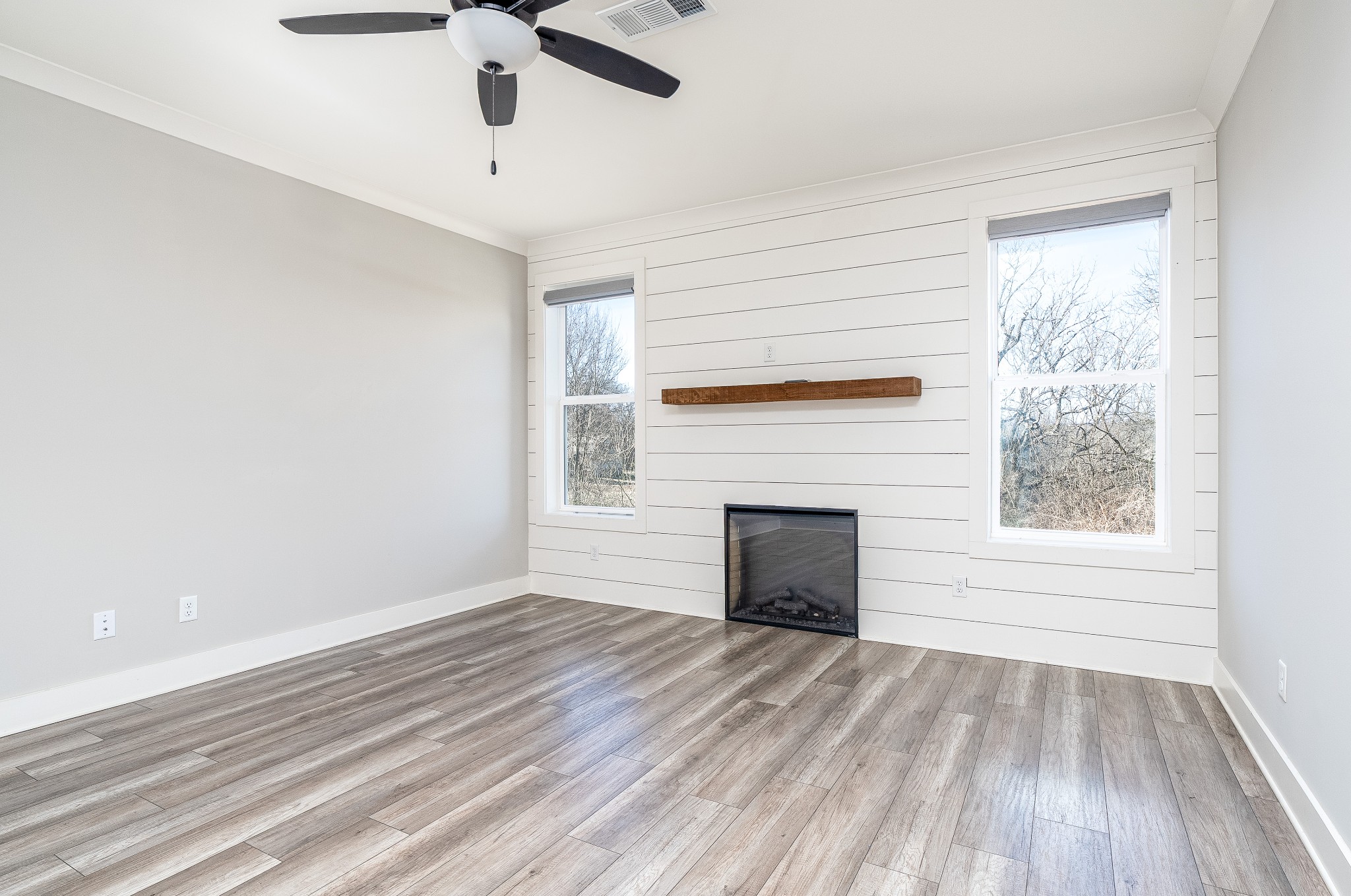 873 Preston Road Antioch, TN 37013 - Photo 16 of 36 wooden floor fireplace and windows in an empty room