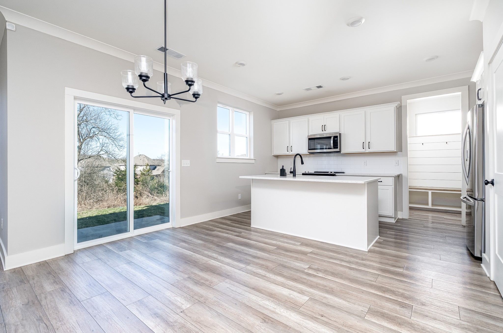 873 Preston Road Antioch, TN 37013 - Photo 7 of 36 a view of kitchen with granite countertop a stove oven and a wooden floor