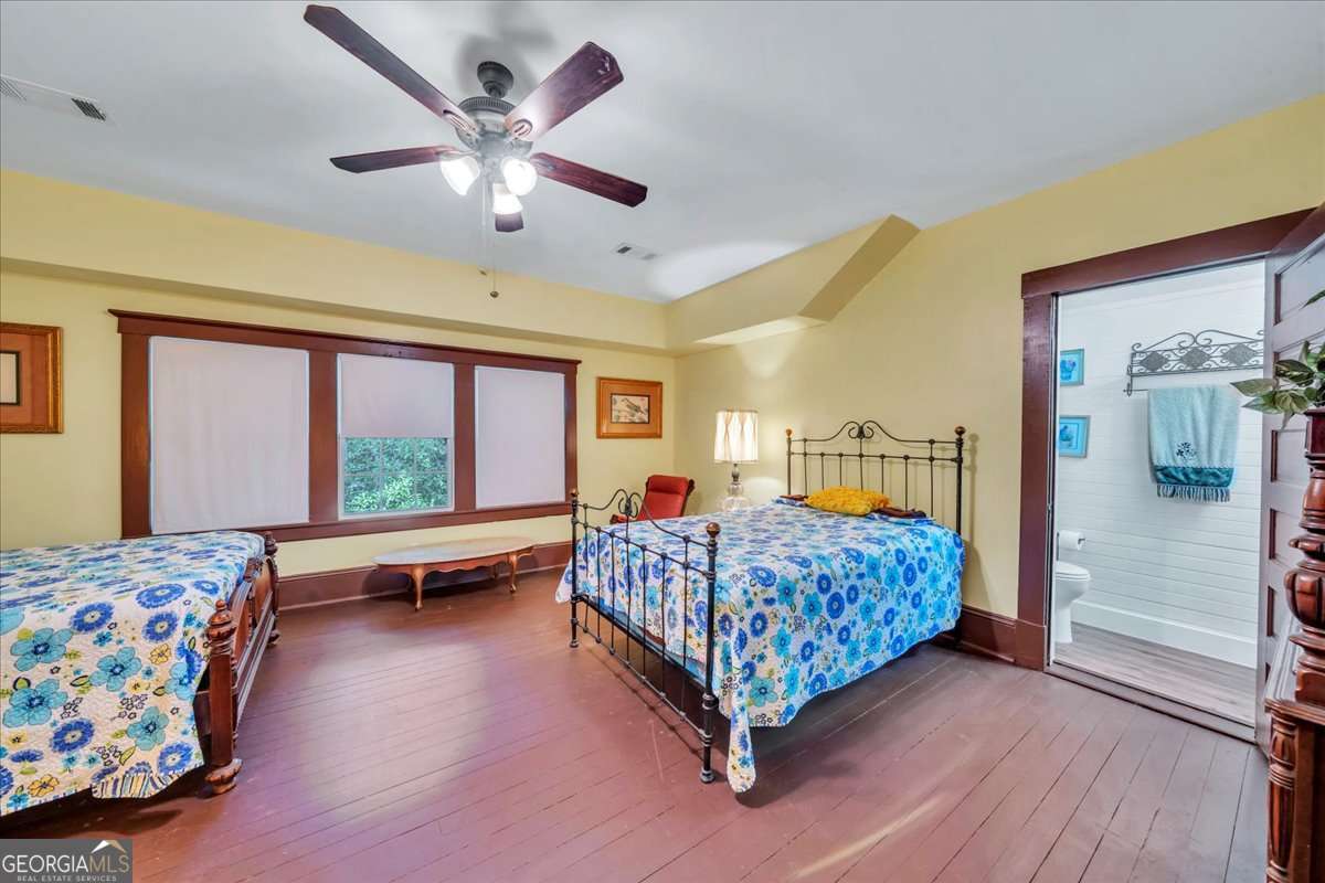 212 East Union Street Vienna, GA 31092 - Photo 34 of 62 a bedroom with a bed and a chandelier