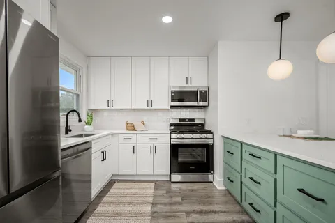 a bathroom with a double vanity sink mirror and toilet
