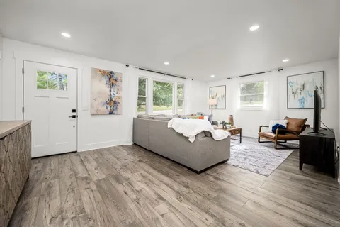 a kitchen with stainless steel appliances granite countertop a stove a sink and a refrigerator