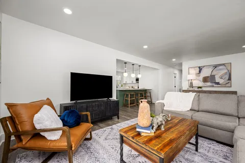 a kitchen with kitchen island granite countertop a sink cabinets and stainless steel appliances