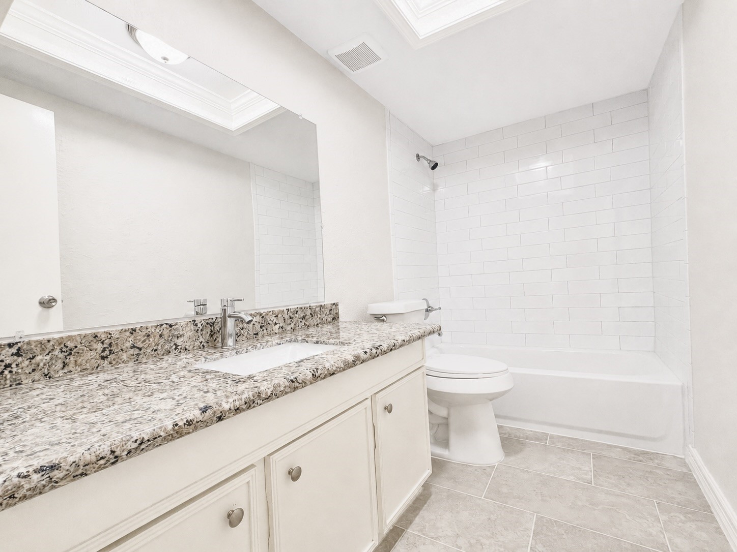 8407 Riverside Walk Lane Houston, TX 77064 - Photo 28 of 33 Secondary bath featuring granite countertops, fresh paint, and a tub/shower combination with classic subway tile.