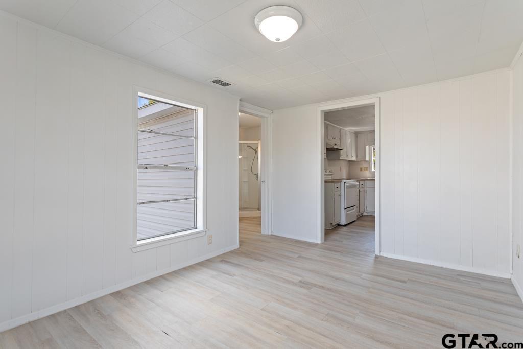 210 Cooper Street Lindale, TX 75771 - Photo 16 of 23 an empty room with wooden floor closet and windows