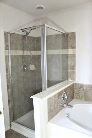 a bathroom with a shower and a sink