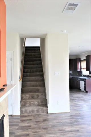 a view of a kitchen with wooden floor and electronic appliances