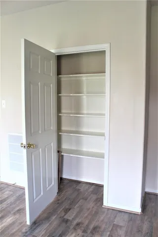 a view of walk in closet with empty racks