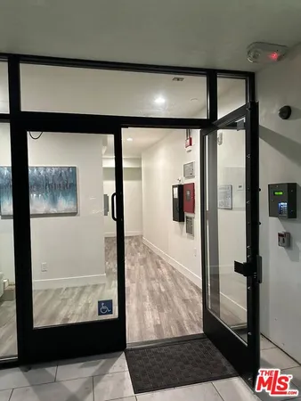 a picture of a room with a window and a picture on the wall