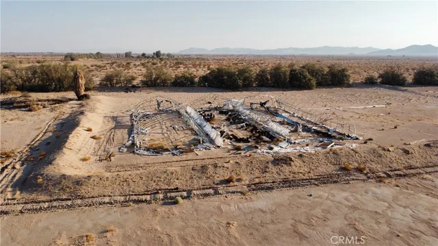 an aerial view of house with yard and ocean view