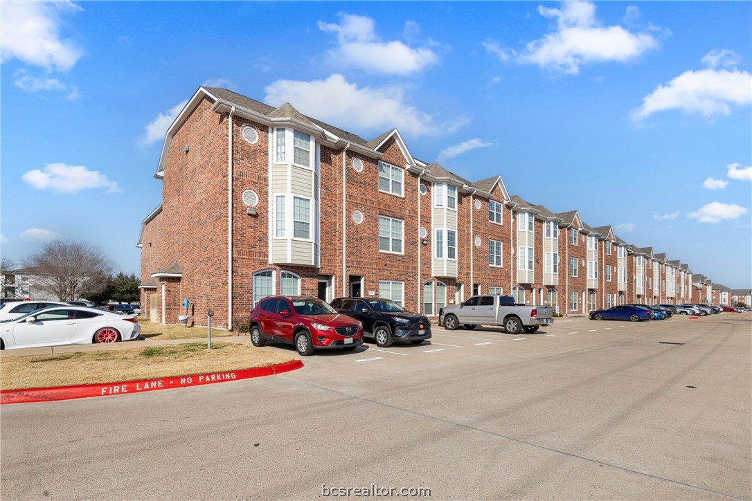 1198 Jones-Butler Road, Unit 3005 College Station, TX 77840 - Photo 23 of 24 a building with cars parked in front of it
